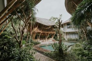 a resort with a swimming pool and a building at ZIN Canggu Resort & Villas in Canggu