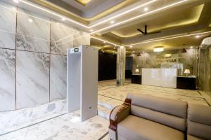 a lobby with a couch and marble walls at Hotel Stay Villa Near Delhi Airport in New Delhi