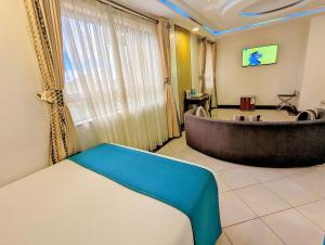 a room with a bath tub and a table at Melili Hotel in Nairobi