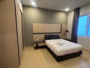 a bedroom with a bed and a large window at Windmill Upon Hills & Geo38 Genting in Genting Highlands