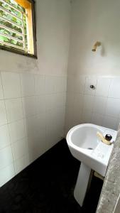 a bathroom with a white sink and a window at riVer in Pelena