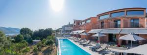 a hotel with a pool in front of a building at IL Mare Plataria in Plataria