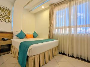 a bedroom with a bed with a large window at Melili Hotel in Nairobi