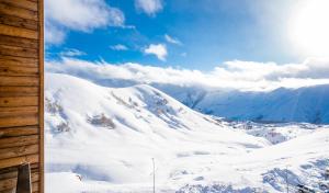 a view of a snow covered mountain from a cabin at 2-room Apartment NFT New Gudauri 505 in Gudauri