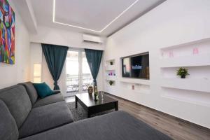 a living room with a couch and a tv at Athenian Comfort Haven in Athens