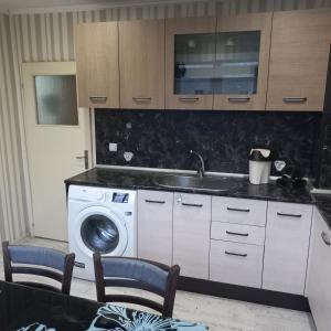 a kitchen with a sink and a washing machine at ПЕТРОВ 1 in Vratsa