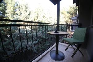 a balcony with a table and a chair and a window at Raymar Hotels Muğla in Mugla +9 photos