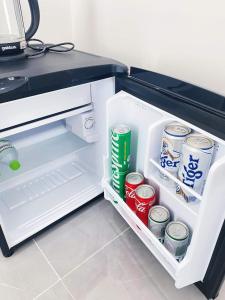 an open refrigerator with drinks and cans of soda at Mango Beach Hotel & Camping in Ấp Khánh Phước (1)