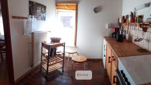 a kitchen with a counter and a table in it at Ferienwohnung Vogel in Mustin