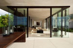 a glass extension of a house with a living room at Alila Villas Uluwatu in Uluwatu