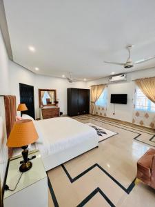 a bedroom with a large bed and a flat screen tv at The Gateway islamabad in Islamabad