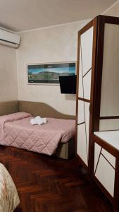 a small bedroom with a bed and a window at Hotel Sirio in Rotonda