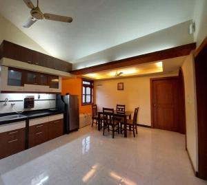 a kitchen and dining room with a table and chairs at 2BHK Modern Suites in North Goa in Saligao