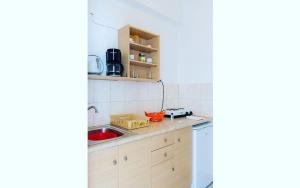 a kitchen with a sink and a counter at Studios Mirtia in Kamares