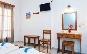 a room with a mirror and a bed and a desk at Studios Mirtia in Kamares