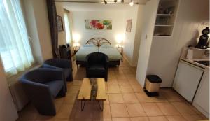 a small living room with a bed and a couch at Gites La Bakénia in Villeneuve-sur-Lot