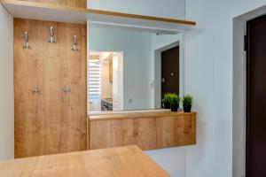 a bathroom with a mirror and a wooden counter at Montana Popa ApartHotel in Blaj