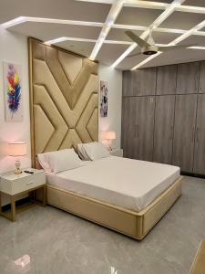 a bedroom with a large bed and two night stands at The Gateway islamabad in Islamabad