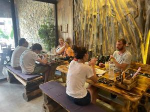 a group of people sitting at tables in a restaurant at Lapis Restaurant and Hostel in Vũ Lâm