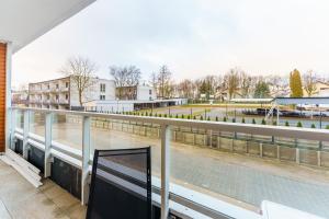 a balcony with a view of a body of water at Apartament Przystań Ku Morzu by HolidaySun in Sianozety