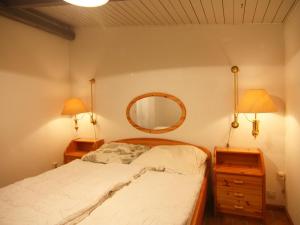 a bedroom with a bed and two lamps and a mirror at Holiday home in Medelby in Medelby