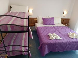 A bed or beds in a room at Hotel Sara*** Cesenatico