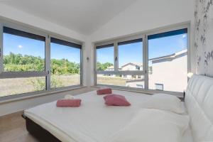 a bedroom with a large white bed with windows at Villa Liv by Istrialux in Hreljići +32 photos