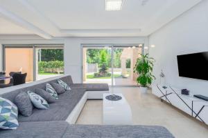 a living room with a couch and a flat screen tv at Villa Liv by Istrialux in Hreljići