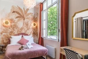 a bedroom with a pink bed with a teddy bear on it at Sophie Stay - Le Mucha - King size bed - AC in Paris