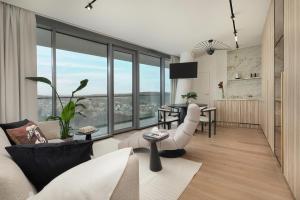 a living room filled with furniture and a large window at WAVE 10th Floor Baltic View in Międzyzdroje