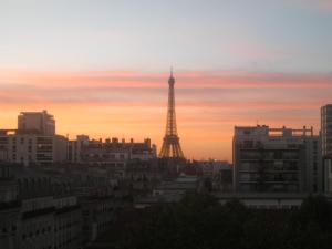 a view of the eiffel tower at sunset at VOLONTAIRES EIFFEL TOWER PARIS in Paris