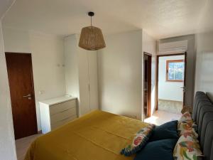 a bedroom with a bed and a couch in it at Alojamento Local - Casa Zé Santos - Aldeias do Xisto - Sobral de São Miguel - Covilhã in Sobral de São Miguel