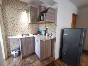 a kitchen with a sink and a refrigerator at 50 Galena Affordable Luxury in Roodepoort