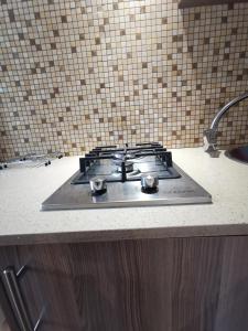 a stove top with three burners on a kitchen counter at 50 Galena Affordable Luxury in Roodepoort