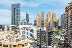 a view of a city skyline with tall buildings at Elegant 3BR in JBR w/ partial Marina View in Dubai