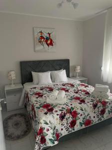 a bedroom with a large bed with a floral bedspread at Motel restoran Sunce in Sremska Kamenica