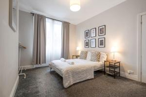 1 dormitorio con cama y ventana grande en Beautiful Apartment with Parking, en Hexham