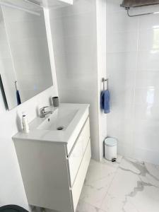 a white bathroom with a sink and a mirror at Casa Malibu El Rincon Pool view Playa Flamenca in Playa Flamenca