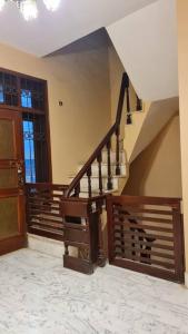 a staircase in a house with a wooden door at 6 Bedroom private home in Dha Lahore- Phase1 Entire House in Lahore