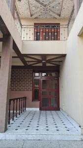 a building with a red door and a balcony at 6 Bedroom private home in Dha Lahore- Phase1 Entire House in Lahore