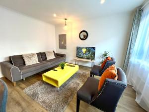 a living room with a couch and a table at Pomelo Tree Apartment in Cambridge