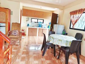 a kitchen and dining room with a table and chairs at Camotes Palanas Beach Stay in Himensulan