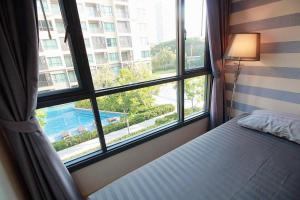 a bed in a room with a large window at Let’s me sea@Rain Cha-am in Cha Am +13 photos