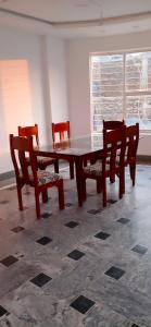 a table and chairs in a room with a table and a window at Ihram Hotel And Guest House in Swat +75 photos