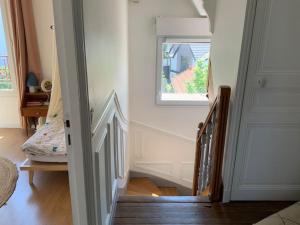 un escalier menant à une chambre avec fenêtre. dans l'établissement Superbe meulière familiale, à Rosny-sous-Bois