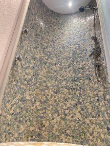 a bathroom with a shower with a tile floor at Chalet - Urlaub bei Freunden in Wagrain