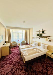 Postel nebo postele na pokoji v ubytování Hotel Nevis Wellness & SPA