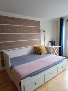 a bedroom with a bed with a wooden headboard at Apartment am Bach in Augsburg