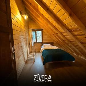 a bedroom in a log cabin with a bed at Zivera Bungalov in Trabzon