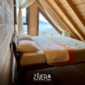 two beds in a room with a window at Zivera Bungalov in Trabzon